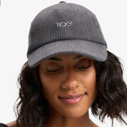 Person wearing a gray cap with 'Roxy' logo on a white background