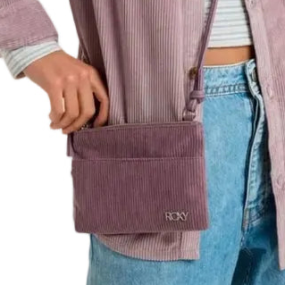Person wearing a purple corduroy vest with a visible brand logo.
