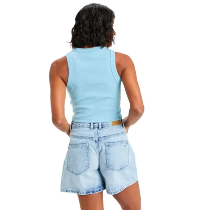 Person wearing a light blue sleeveless top and denim shorts on a white background