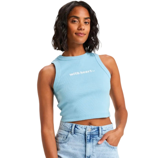 Woman wearing a light blue crop top with 'with heart' text on a plain background
