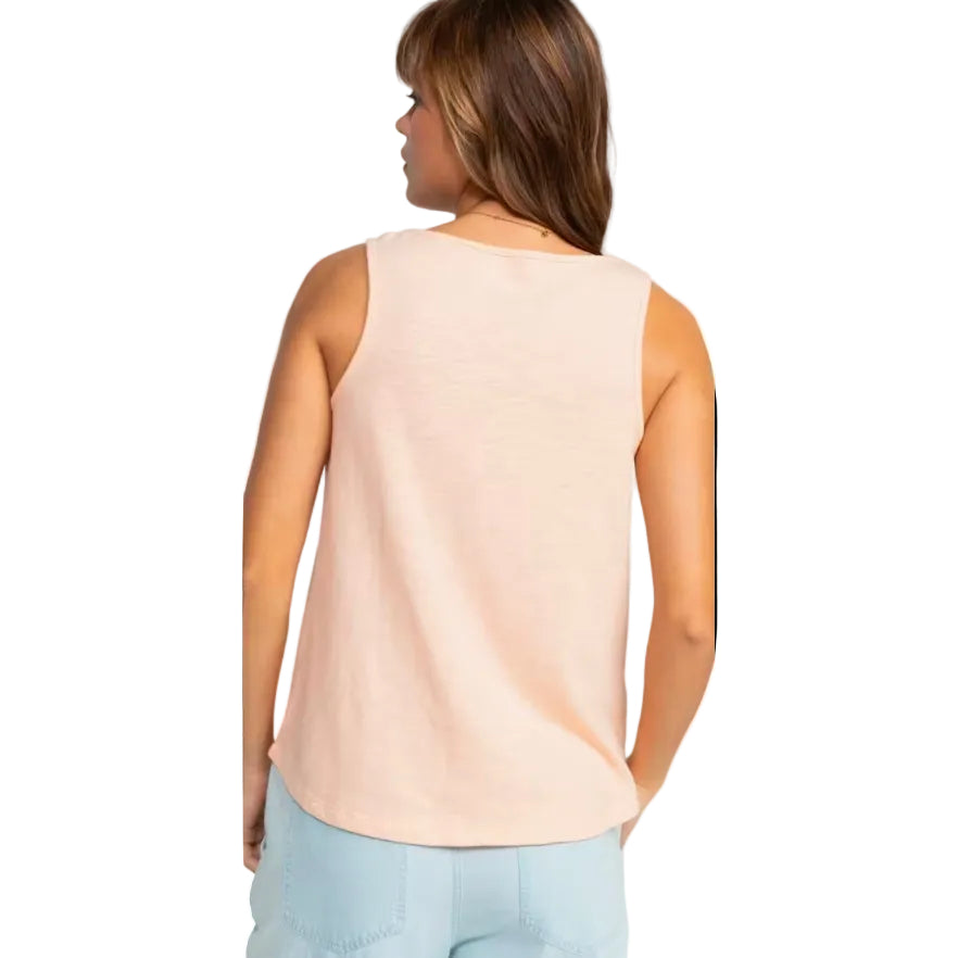Woman wearing a beige sleeveless top on a white background