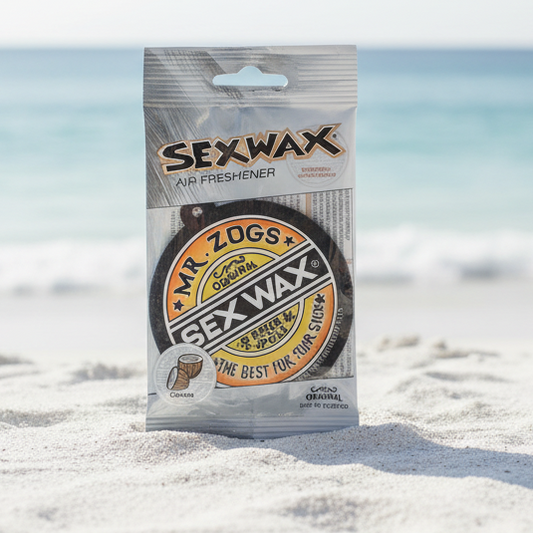 Sexwax air freshener packaging on a beach with ocean in the background