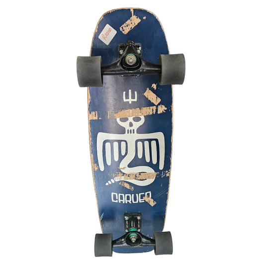 Skateboard with a blue deck and white graphics leaning against a wooden door.