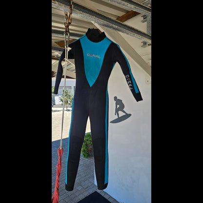 Blue and black wetsuit on a stand with a building and flags in the background