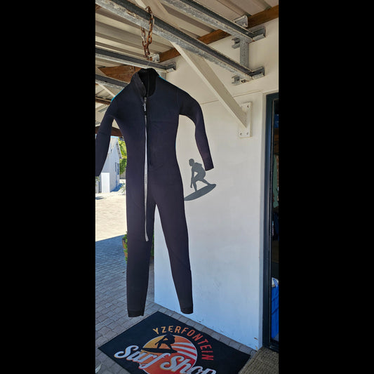 Black wetsuit on a mannequin against a white wall with a logo in the background.