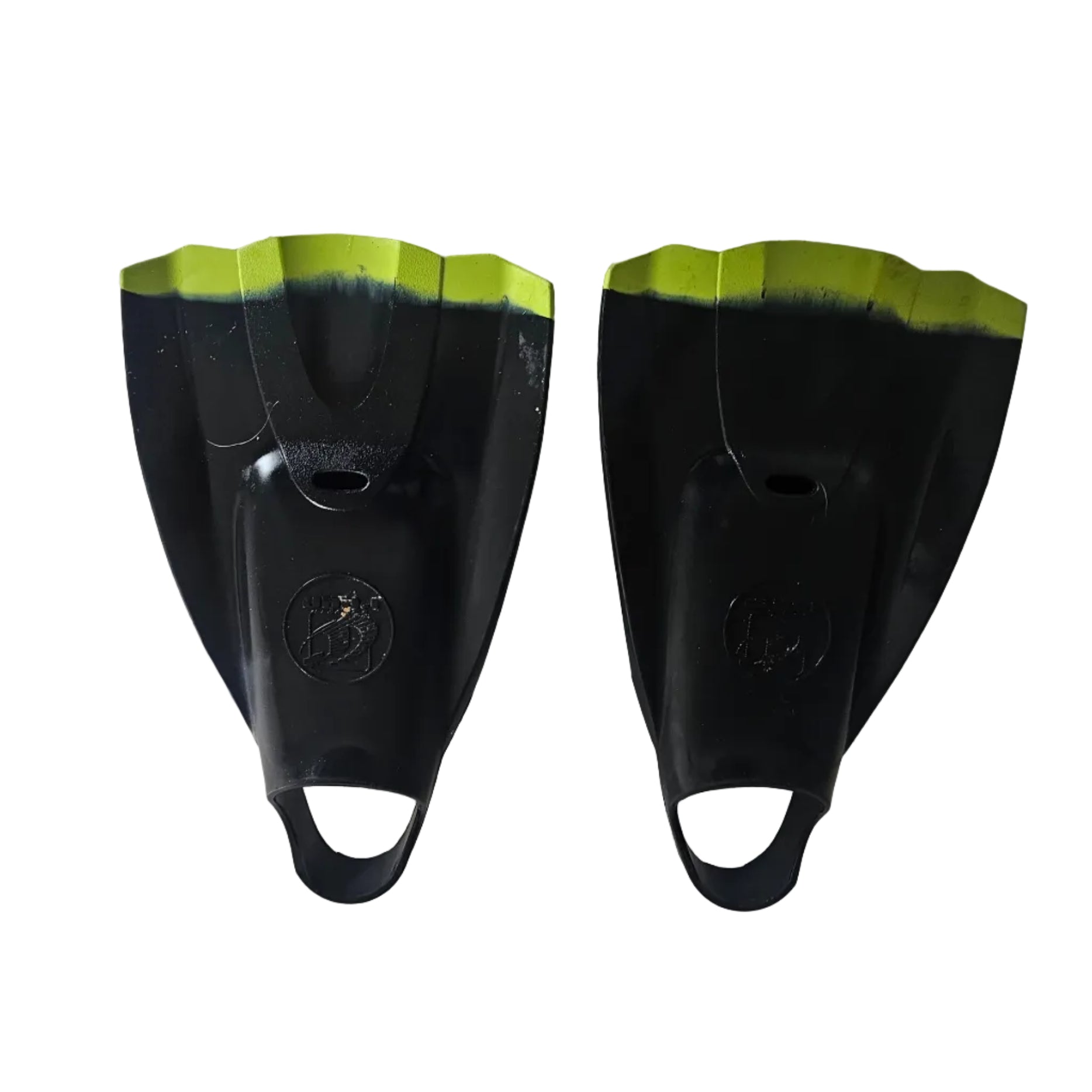 Pair of black swim fins with green tips on a light gray surface