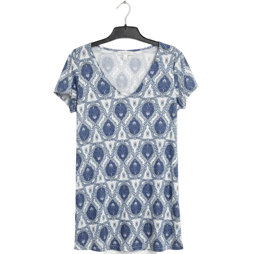 Blue and white patterned dress on a hanger against a white background