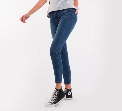 Person wearing blue jeans and black high-top sneakers on a white background