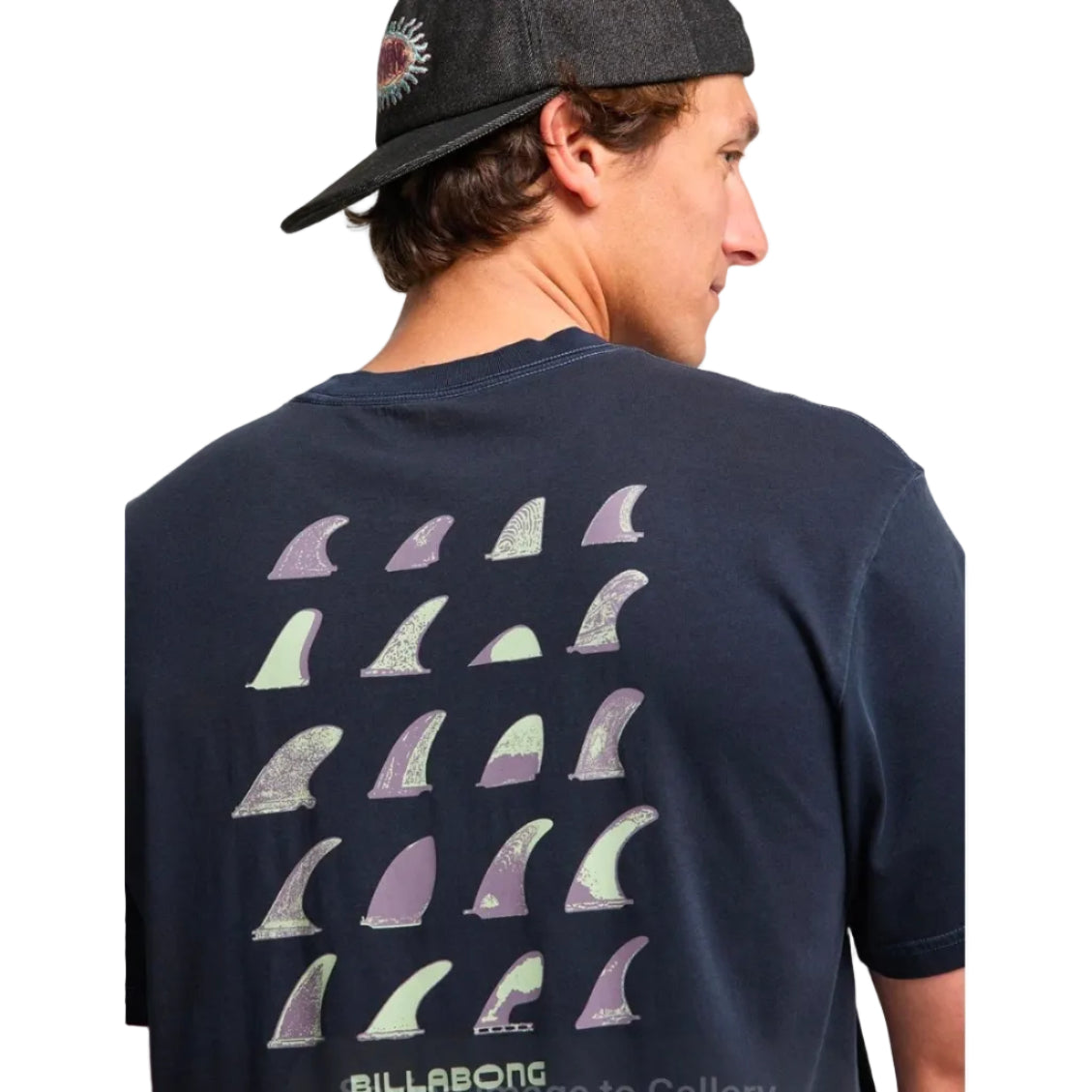 Person wearing a navy blue t-shirt with shark fin designs and 'Billabong' branding.