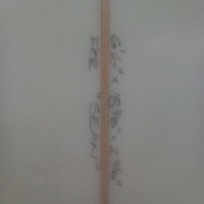 Measurement label on a white surface with text and a line.