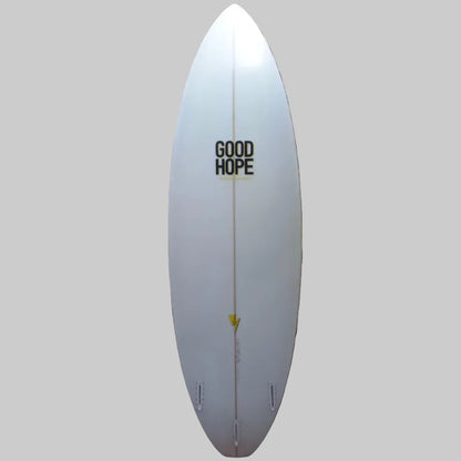 White surfboard with 'Good Hope' branding against a patterned wall.