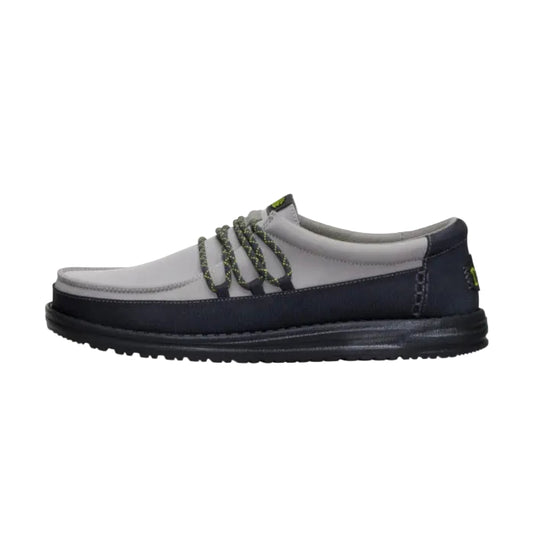Gray and navy shoe with green accents on a white background