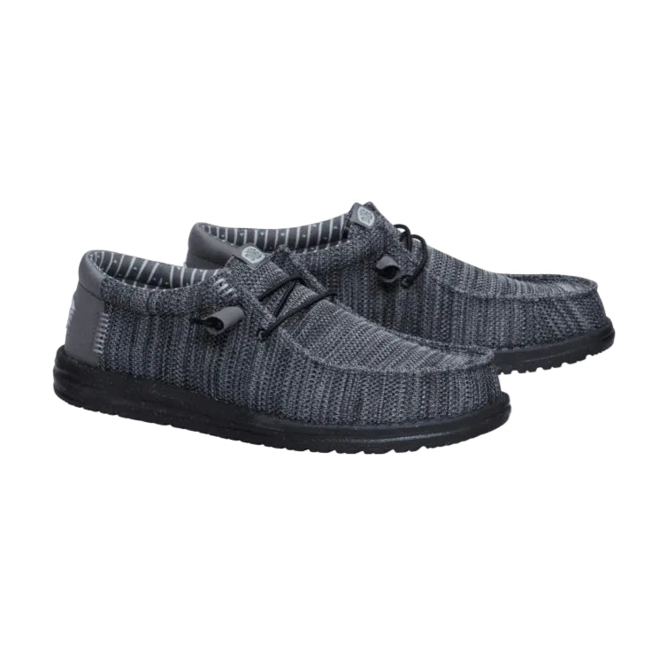 Pair of gray knit shoes with black soles on a white background