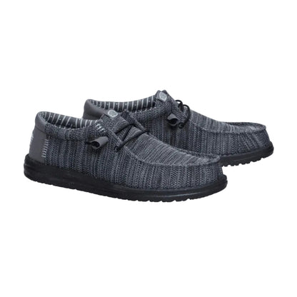 Pair of gray knit shoes with black soles on a white background