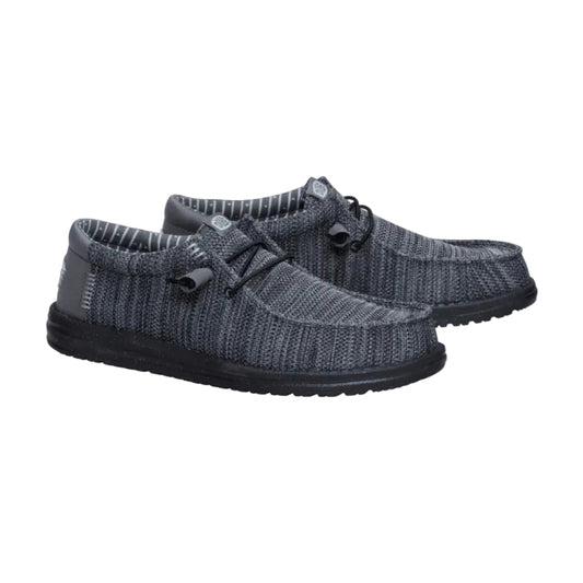 Pair of gray knit shoes with black soles on a white background