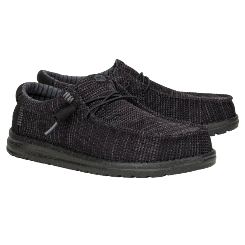 Pair of black knit shoes on a white background