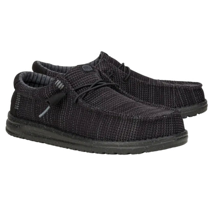 Pair of black knit shoes on a white background