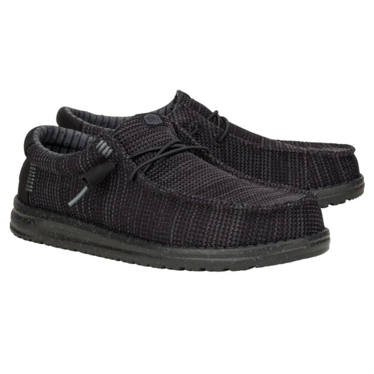 Pair of black knit shoes on a white background
