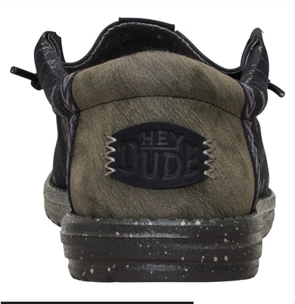 Green sneaker with 'Hey Dude' logo on a white background