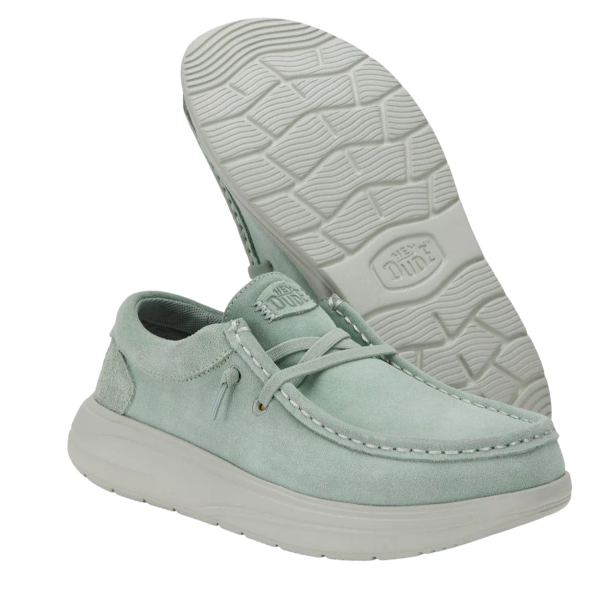 Light green sneakers with white soles on a white background