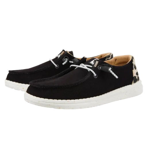 Black casual shoes with white soles on a white background