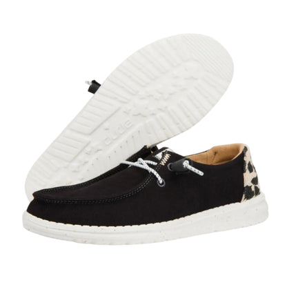 Black casual shoe with white sole on a white background