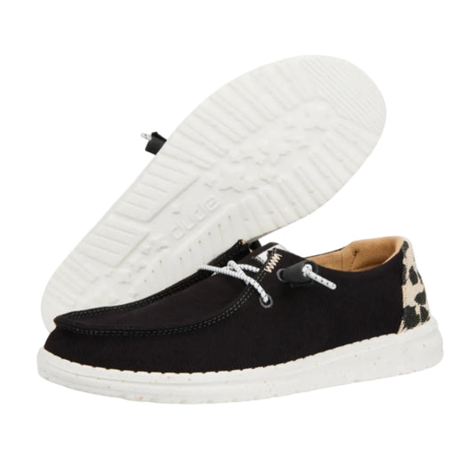 Black casual shoe with white sole on a white background