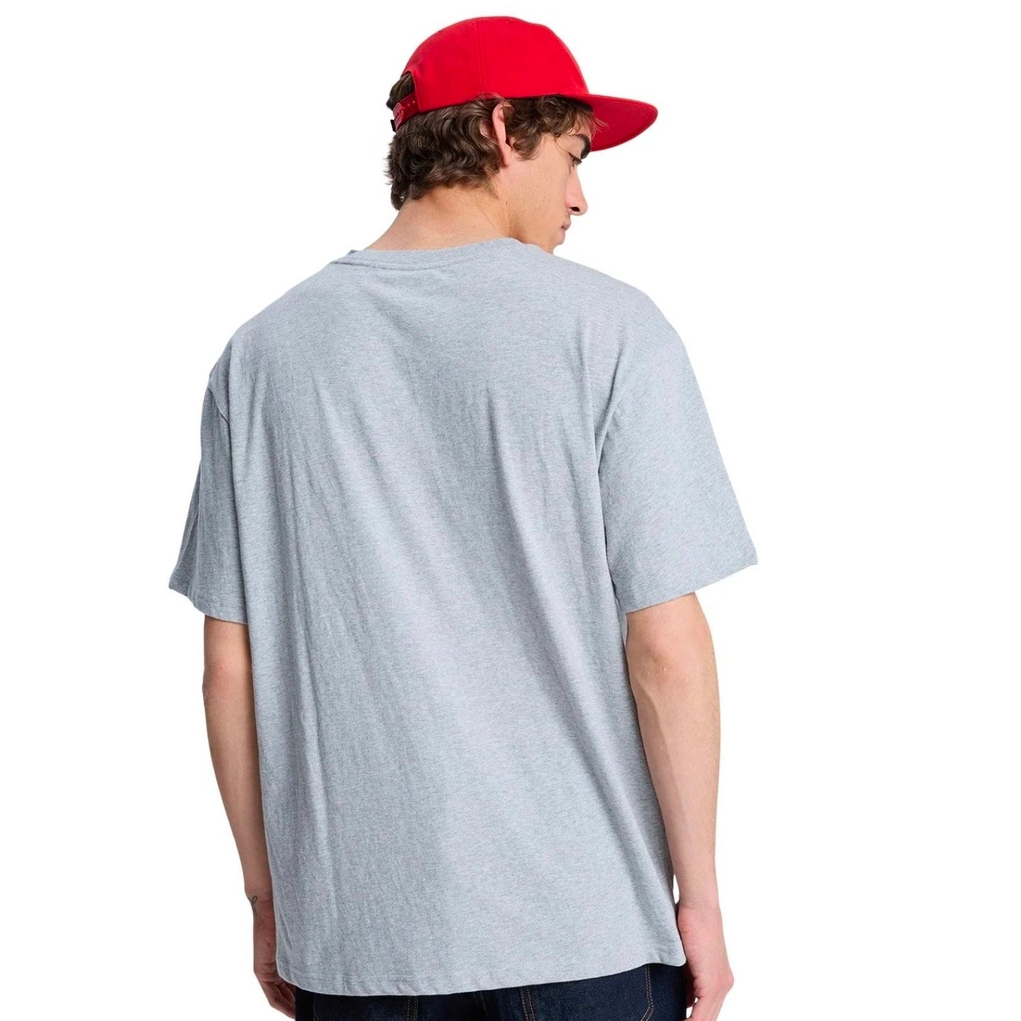 Person wearing a gray t-shirt and red cap from behind on a white background