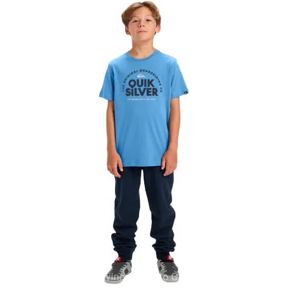 Child wearing a blue Quiksilver t-shirt on a white background