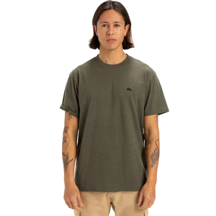 Person wearing a green t-shirt with a small logo on a white background