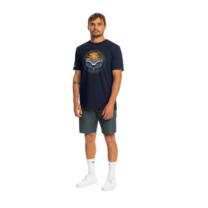 Man wearing a navy blue t-shirt with a graphic design on a white background