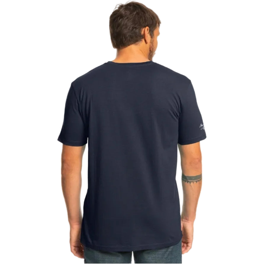 Man wearing a navy blue t-shirt with a visible brand logo on the back.