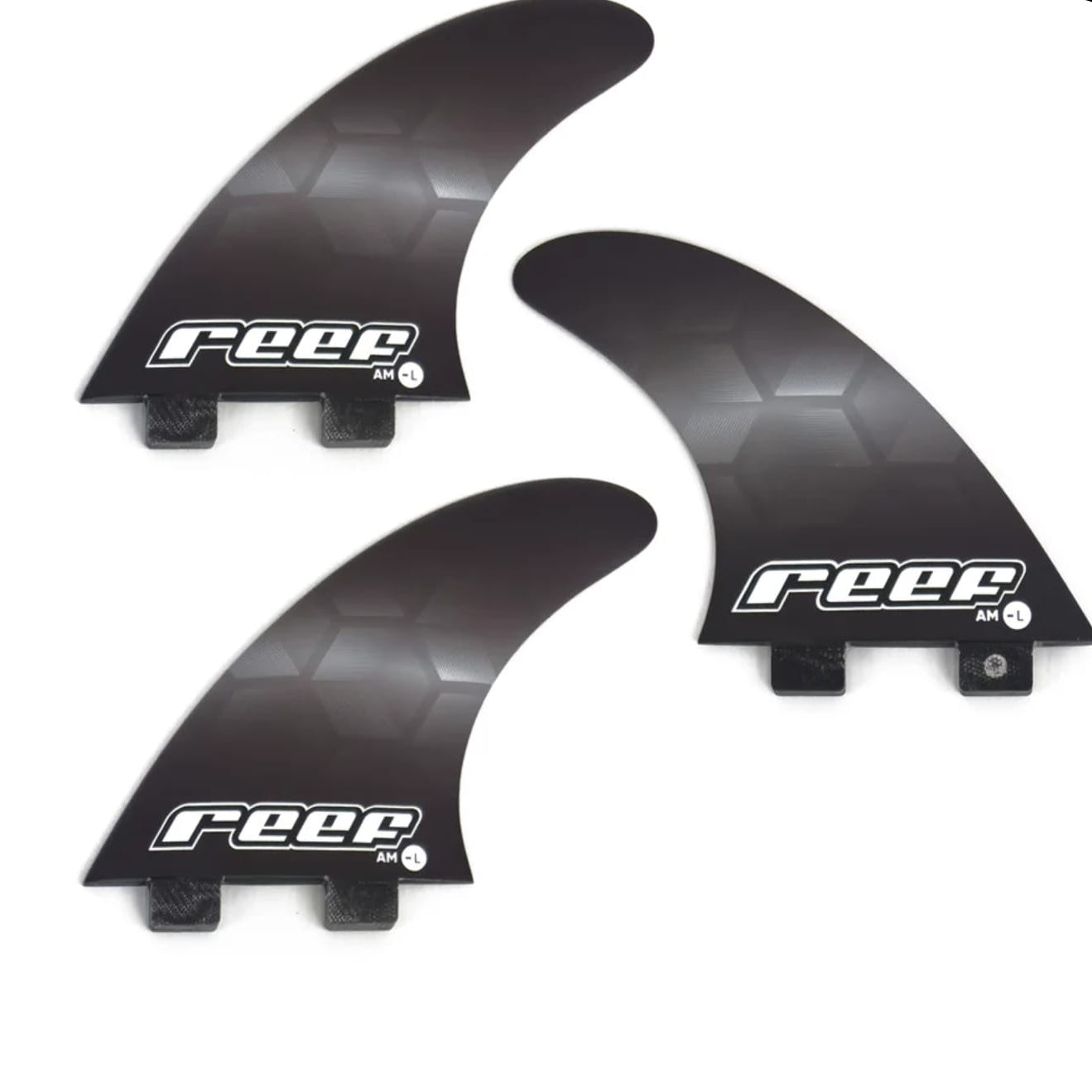 Three black surfboard fins with 'reef' branding on a white background