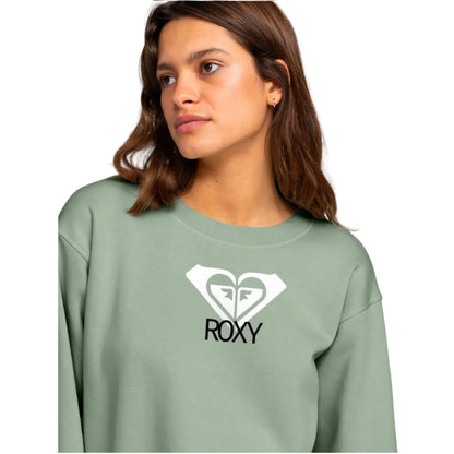 Woman wearing a green sweatshirt with a Roxy logo on a white background