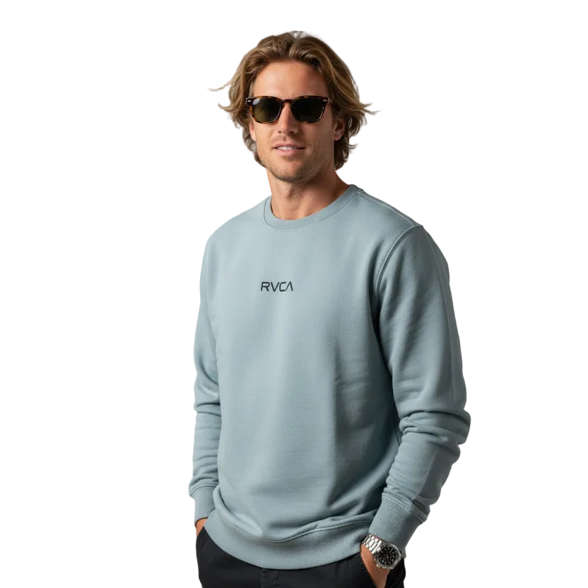 Man wearing a light blue sweatshirt with 'RVCA' logo, sunglasses, and a watch against a plain background.